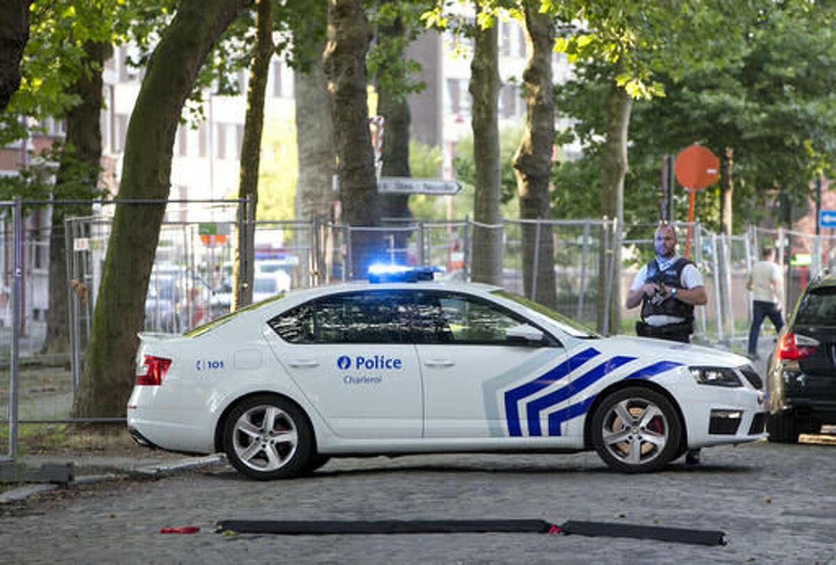 Police officers secure the scene, near the police headquarters in Charleroi, Belgium, Saturday, Aug. 6, 2016. ﻿ Two female officers were attacked and wounded by a man wielding a machete and shouting "Allahu Akhbar" outside a police station in the Belgian city of Charleroi on Saturday, police said. (AP Photo/Virginia Mayo)