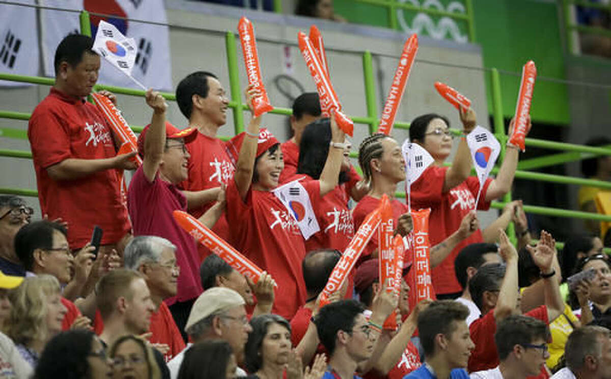 South Korean fans cheer during the women's preliminary handball match between Russia and South Korea at the 2016 Summer Olympics in Rio de Janeiro, Brazil, Saturday, Aug. 6, 2016. (AP Photo/Ben Curtis)