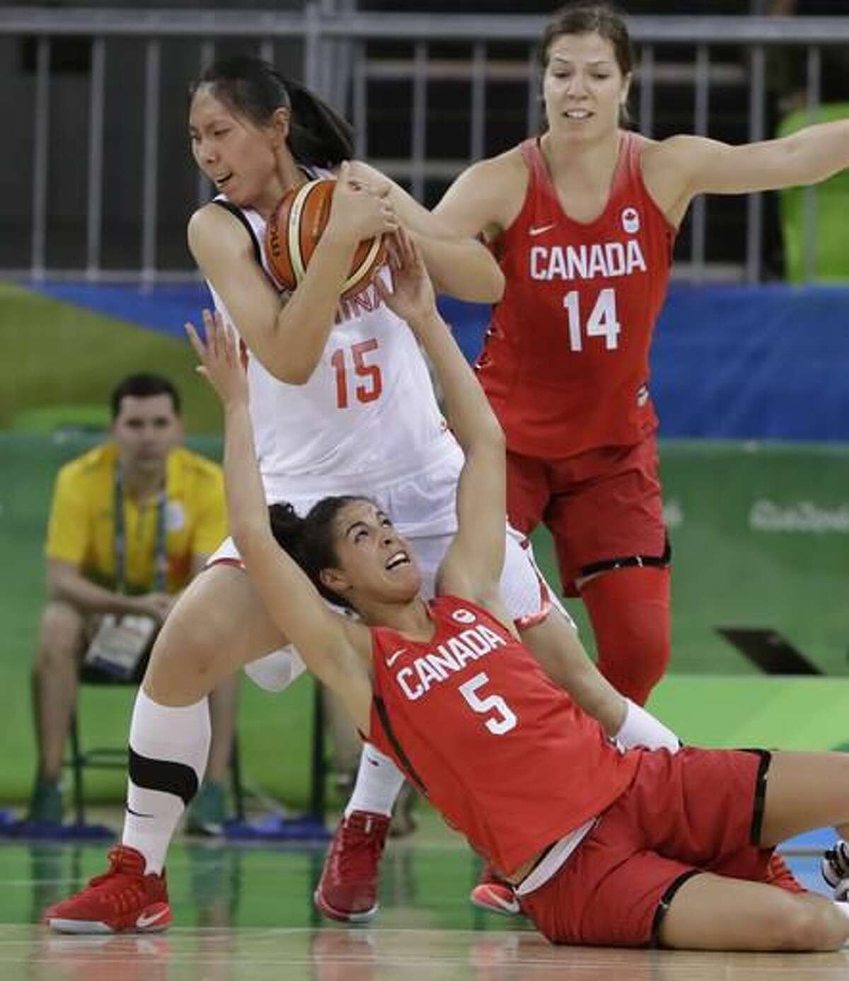 Canada guard Kia Nurse (5) reaches on China center Nan Chen for the ball during the first half of a women's basketball game at the Youth Center at the 2016 Summer Olympics in Rio de Janeiro, Brazil, Saturday, Aug. 6, 2016. (AP Photo/Carlos Osorio)