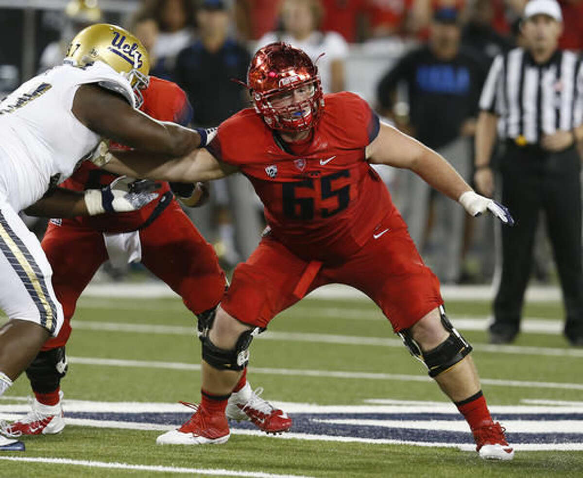 FILE - In this Sept. 26, 2015, file photo, Arizona offensive lineman Zach Hemmila (65) blocks a UCLA player during the first half of an NCAA college football game in Tucson, Ariz. Hemmila, a senior offensive lineman, has died in his sleep, Arizona athletic director Greg Byrne said Monday, Aug. 8, 2016. Byrne and Arizona coach Rich Rodriguez told the team of Hemmila's death after practice on Monday morning. (AP Photo/Rick Scuteri, File)