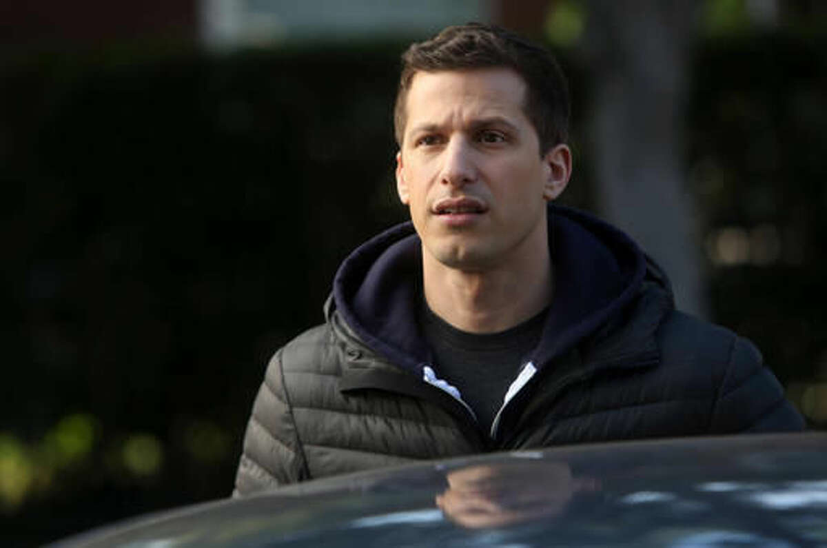 In this image released by Fox, Andy Samberg portrays Jake in a scene from the series, "Brooklyn Nine-Nine." Fox comedies "New Girl" and "Brooklyn Nine-Nine" will cross over in back-to-back episodes airing Tuesday, Oct. 11. ( John P. Fleenor/FOX via AP)