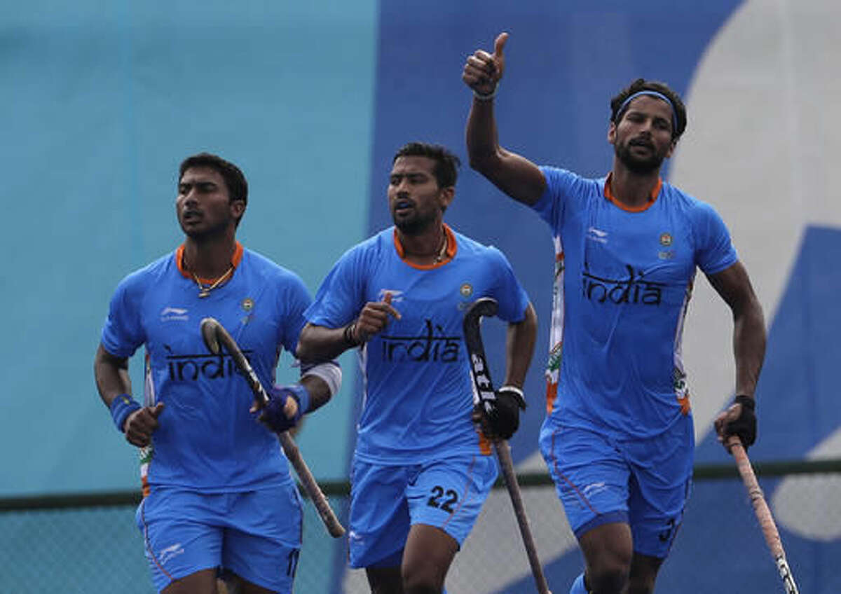 India's Rupinder Pal Singh, right, celebrates his goal against Germany during a men's field hockey match at 2016 Summer Olympics in Rio de Janeiro, Brazil, Monday, Aug. 8, 2016. (AP Photo/Hussein Malla)