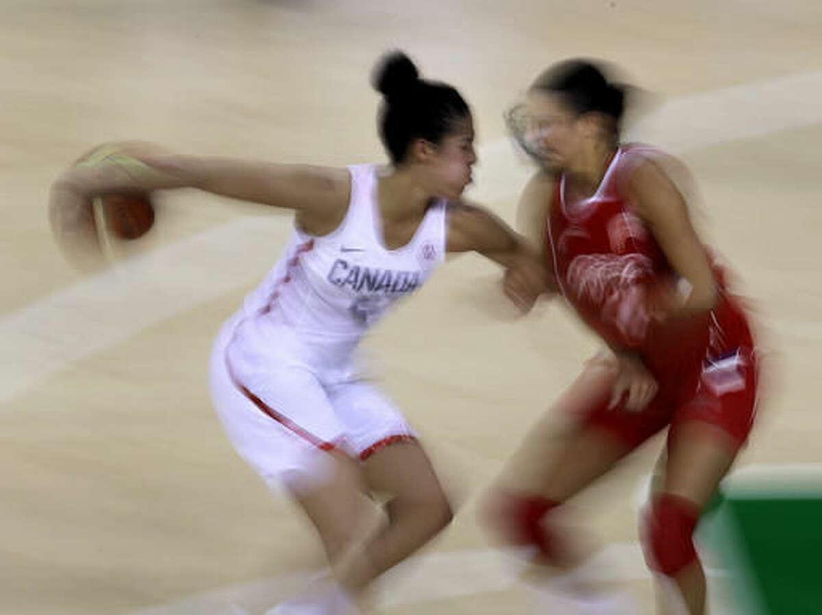 Canada's Kia Nurse, left, is pressured by Serbia's Ana Dabovic during the second half of a women's basketball game at the 2016 Summer Olympics in Rio de Janeiro, Brazil, Monday, Aug. 8, 2016. Canada won 71-67. (AP Photo/Charlie Riedel)