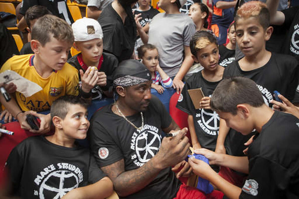Recently retired NBA star Amare Stoudemire signs autographs in Jerusalem, Monday, Aug. 8, 2016. Stoudemire signed a two-year contract Monday to play for Israeli team Hapoel Jerusalem. Stoudemire hosted some 140 Jewish and Arab kids to his basketball peace camp on Monday as he prepared to join the Israeli league. (AP Photo/Dan Balilty)