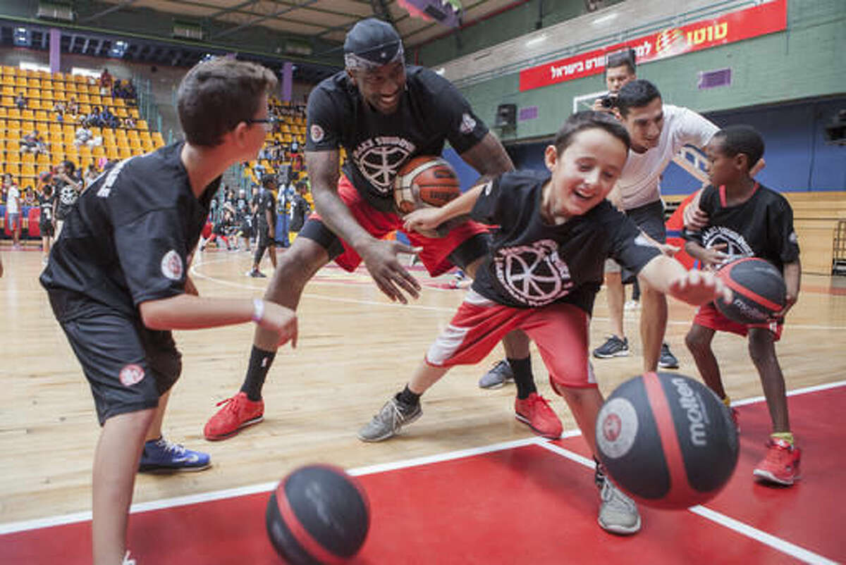 Recently retired NBA star Amare Stoudemire trains kids in Jerusalem, Monday, Aug. 8, 2016. Stoudemire signed a two-year contract Monday to play for Israeli team Hapoel Jerusalem. Stoudemire hosted some 140 Jewish and Arab kids to his basketball peace camp on Monday as he prepared to join the Israeli league. (AP Photo/Dan Balilty)