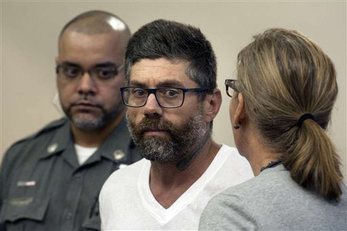 Walter DaSilva, center, of Danbury, Conn., appears in Superior Court for an extradition hearing in Bridgeport, Conn., on Monday, Aug. 8, 2016. DaSilva was arrested in Bridgeport on Friday, and is wanted as a suspect in the July 3 fatal shooting of his 19-year old daughter, Sabrina DaSilva, in New Bedford, Mass. (Ned Gerard/Hearst Connecticut Media via AP, Pool)