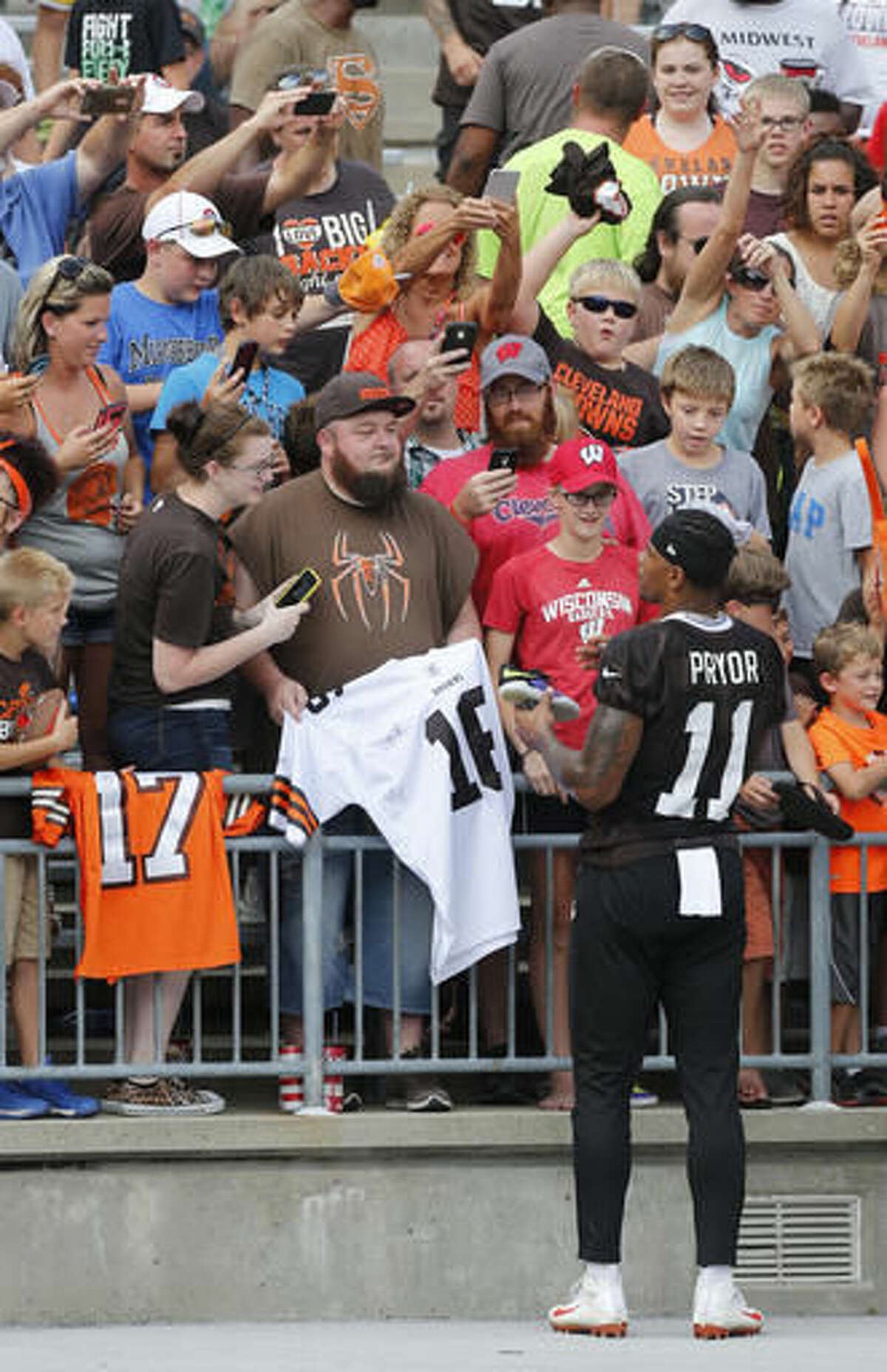 Cleveland Browns wide receiver Terrelle Pryor signs autographs after their orange and brown scrimmage at the NFL football team's training camp Saturday, Aug. 6, 2016, in Columbus, Ohio. (AP Photo/Jay LaPrete)