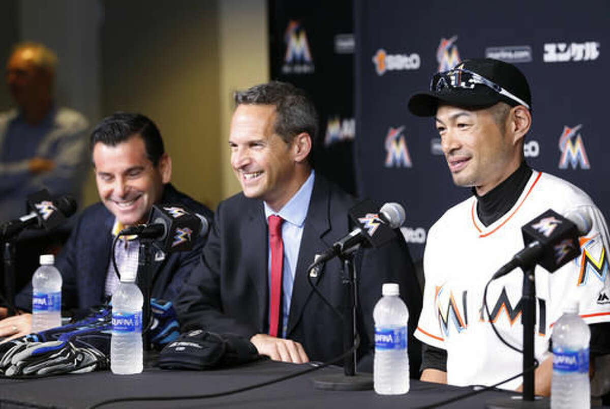 Miami Marlins' Ichiro Suzuki, right, smiles as he speaks about his 3,000 major league hit along with Jeff Idelson, center, president of the National Baseball Hall of Fame and Museum, and Marlins president David Samson, far left, Monday, Aug. 8, 2016, in Miami. (AP Photo/Wilfredo Lee)