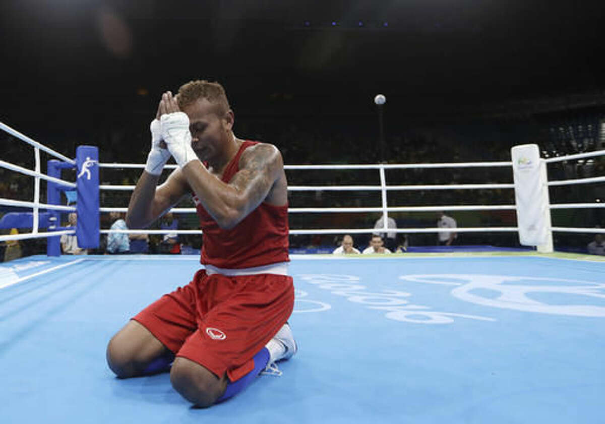Thailand's Amnat Ruenroeng prays after winning a match against Argentina's Perrin Ignacio during a men's lightweight 60-kg preliminary boxing match at the 2016 Summer Olympics in Rio de Janeiro, Brazil, Sunday, Aug. 7, 2016. (AP Photo/Frank Franklin II)