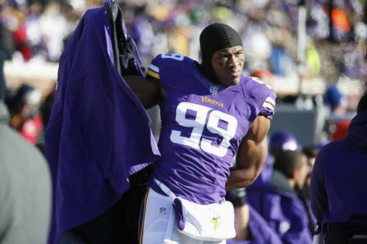 FILE - In this Jan. 10, 2016, file photo, Minnesota Vikings defensive end Danielle Hunter (99) watches from the sideline during the first half of an NFL wild-card football game against the Seattle Seahawks, in Minneapolis. As the youngest player in the NFL last season, defensive end Danielle Hunter showed off plenty of potential as a rookie for the Minnesota Vikings with six sacks. Entering his second year, he's still only 21. (AP Photo/Jim Mone, File)