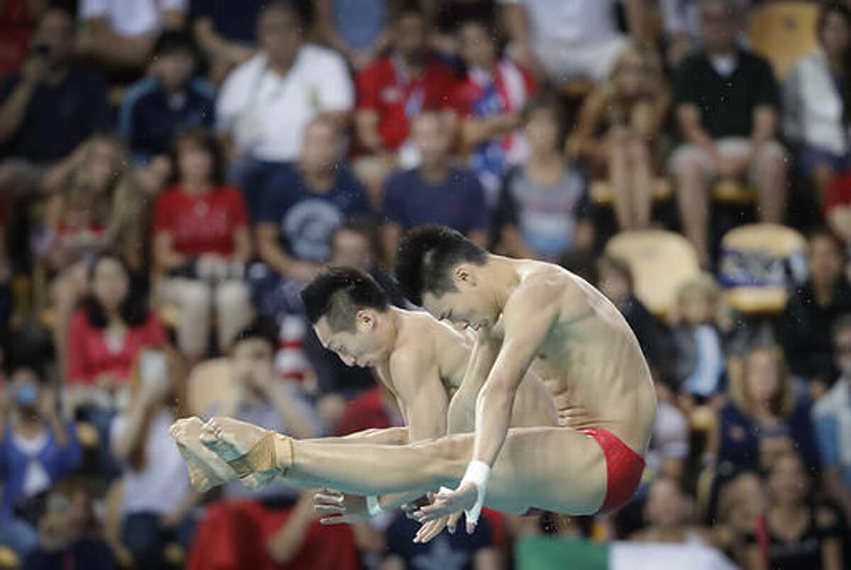 China's Lin Yue, left, and Chen Aisen, right, compete in the men's synchronized 10-meter platform diving final in the Maria Lenk Aquatic Center at the 2016 Summer Olympics in Rio de Janeiro, Brazil, Monday, Aug. 8, 2016. (AP Photo/Wong Maye-E)