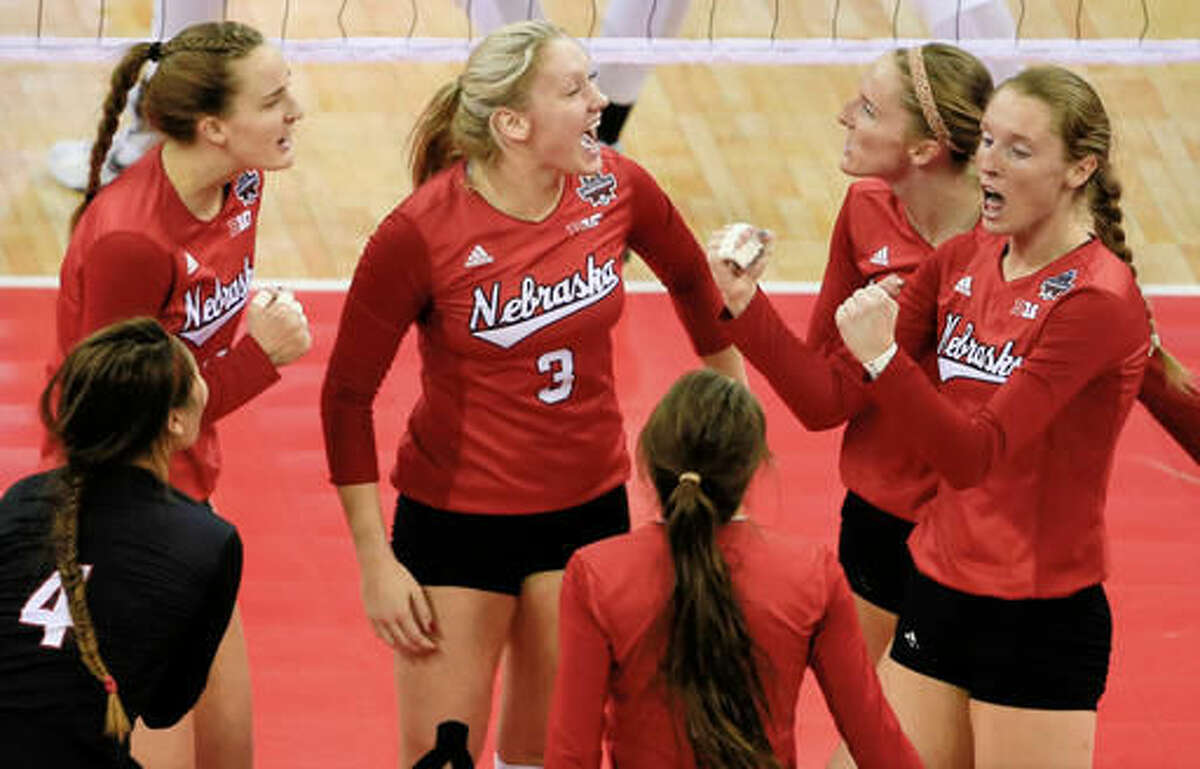 FILE- In this Dec. 19, 2015, file photo, Nebraska players including outside hitter Kadie Rolfzen, right, her twin sister middle blocker Amber Rolfzen, second right, libero Justine Wong-Orantes (4) and setter Kelly Hunter (3), celebrate a point against Texas during the NCAA women's volleyball tournament finals in Omaha, Neb. During Media Day on Monday, Aug. 8, 2016, Nebraska coach John Cook and his players are expected to discuss their hopes of winning a second straight national championship. (AP Photo/Nati Harnik, File)