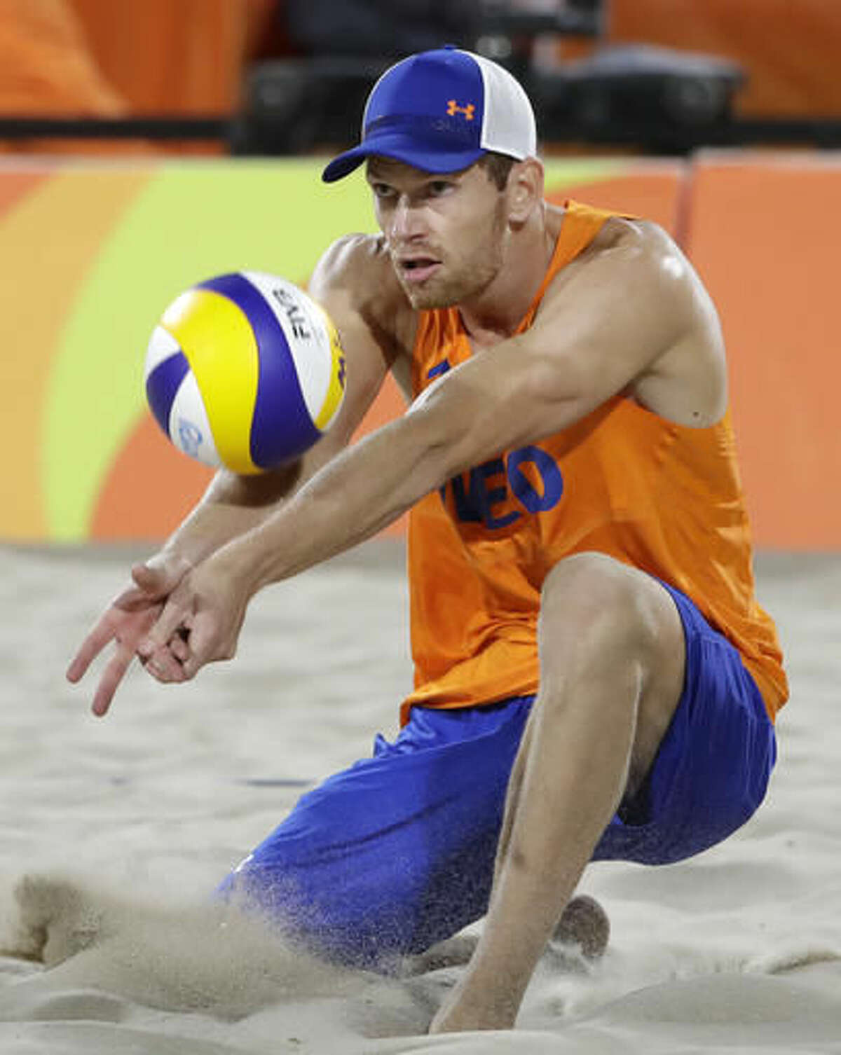 Netherland's Alexander Brouwer digs against Germany during a men's beach volleyball match at the 2016 Summer Olympics in Rio de Janeiro, Brazil, Monday, Aug. 8, 2016. (AP Photo/Marcio Jose Sanchez)