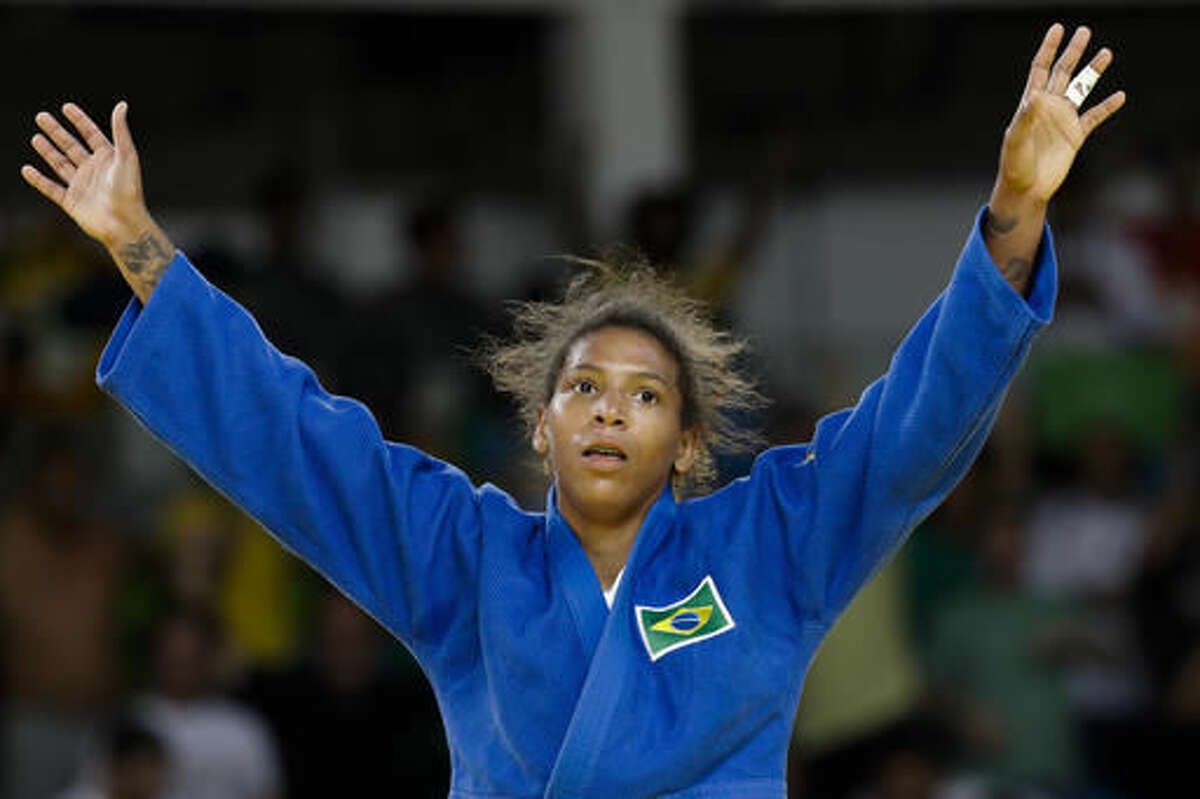 Brazil's Rafaela Silva celebrates after winning the gold medal of the women's 57-kg judo competition at the 2016 Summer Olympics in Rio de Janeiro, Brazil, Monday, Aug. 8, 2016. (AP Photo/Markus Schreiber)
