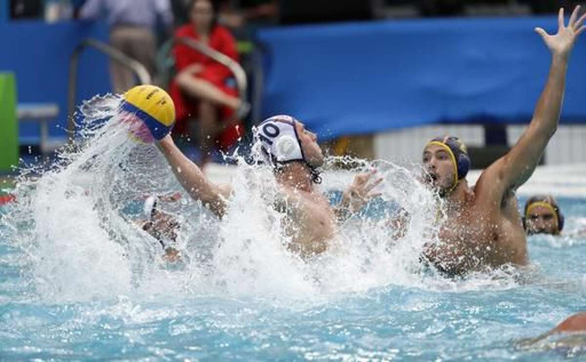 United States' Bret Bonanni, left, takes a shot at goal as Spain's Alberto Munarriz Egana defends during their men's water polo preliminary round match at the 2016 Summer Olympics in Rio de Janeiro, Brazil, Monday, Aug. 8, 2016. (AP Photo/Sergei Grits)