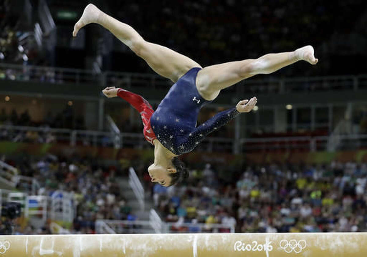 United States' Aly Raisman performs on the balance beam during the artistic gymnastics women's qualification at the 2016 Summer Olympics in Rio de Janeiro, Brazil, Sunday, Aug. 7, 2016. (AP Photo/Rebecca Blackwell)