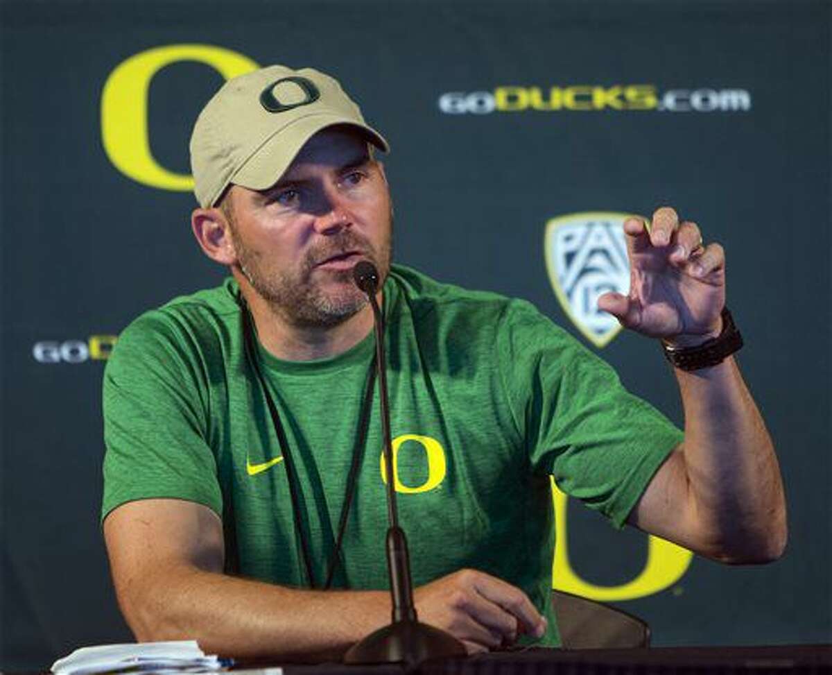 Oregon head coach Mark Helfrich answers questions from members of the media during Oregon NCAA football media day at Autzen Stadium in Eugene, Ore., Monday, Aug. 8, 2016. Helfrich's team enters the season ranked 22nd in the Associated Press college football poll. (Andy Nelson/The Register-Guard via AP)