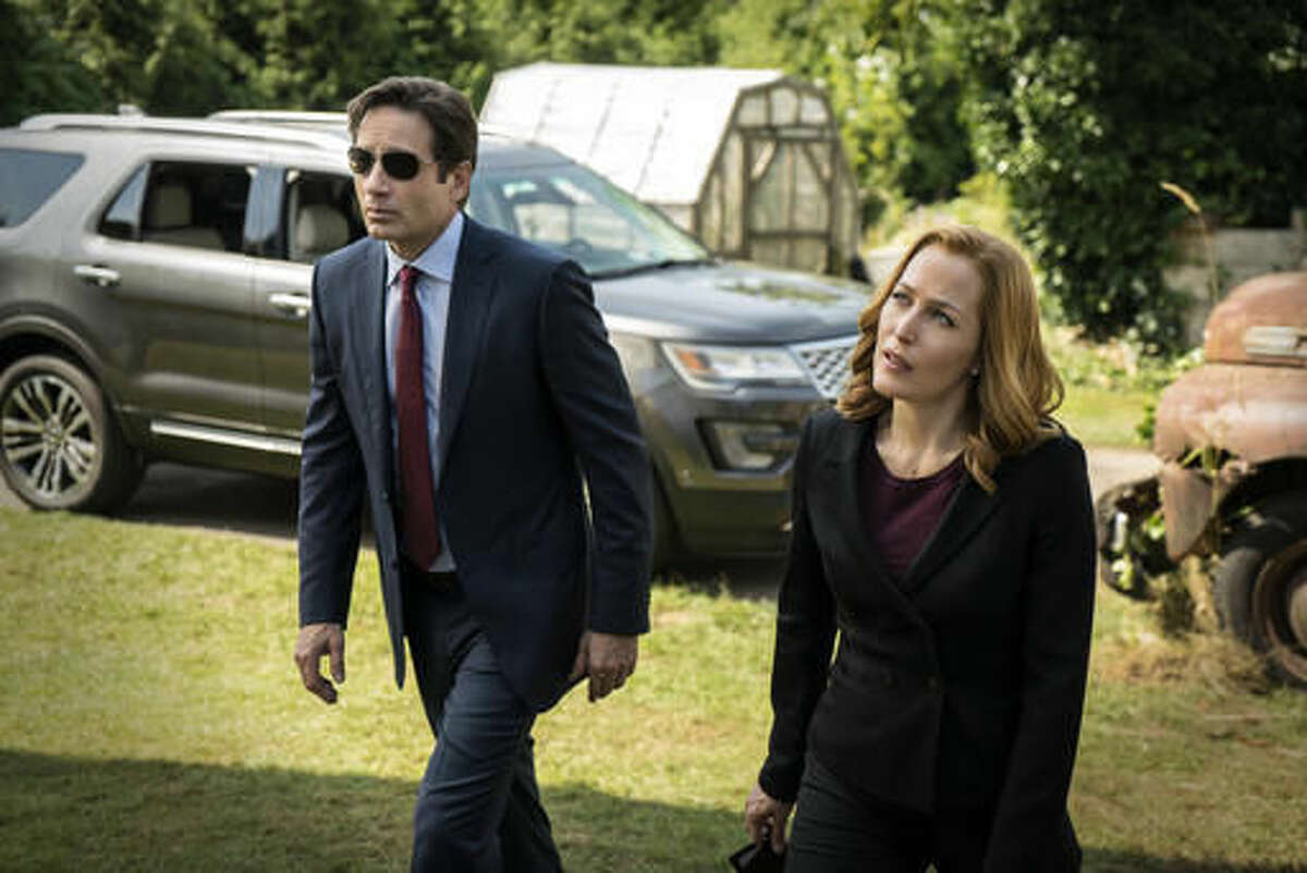 This photo provided by FOX shows, David Duchovny, left, and Gillian Anderson in the "Founder's Mutation" season premiere, part two, episode of "The X-Files," airing Monday, Jan. 25, 2016, 8:00-9:00 PM ET/PT on FOX. Significant talks are underway with "The X-Files" stars Anderson and Duchovny and creator Chris Carter for more of the drama series, Fox's entertainment president said. "Schedules are hard, but we are working hard to get this done and we would love to get another season out soon," programming chief David Madden told a TV critics meeting Monday, Aug. 8, 2016. (Ed Araquel/FOX via AP)