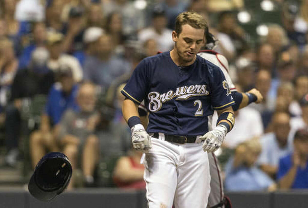 Milwaukee Brewers' Scooter Gennett slams hit helmet down after striking out with two men on base to Atlanta Braves' Jose Ramirez during the eighth inning of a baseball game, Monday, Aug. 8, 2016, in Milwaukee. (AP Photo/Tom Lynn)