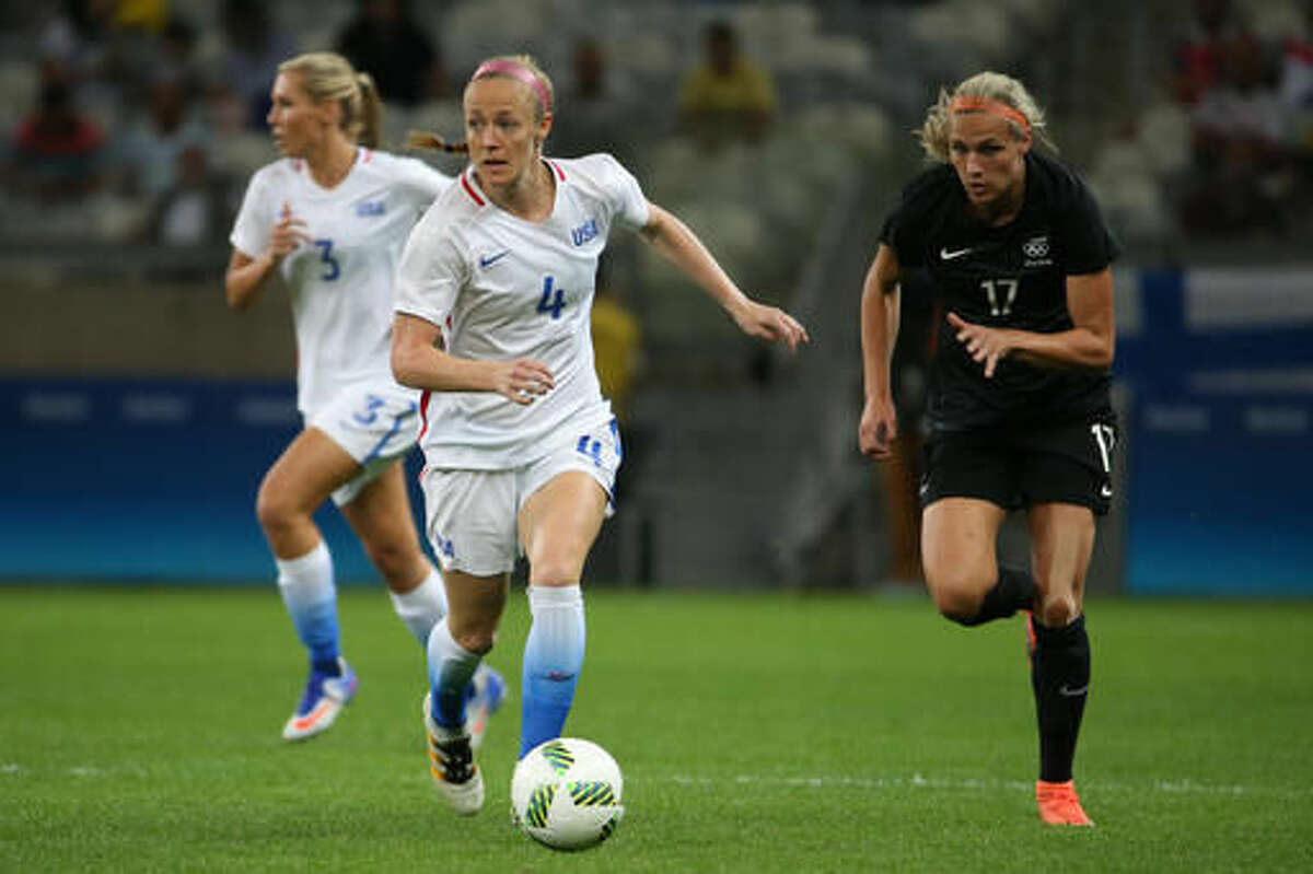 United States' Becky Sauerbrunn, left, dribbles the ball past New Zealand's Hannah Wilkinson, right, during a women's Olympic football tournament match at the Mineirao stadium in Belo Horizonte, Brazil, Wednesday, Aug. 3, 2016. (AP Photo/Eugenio Savio)