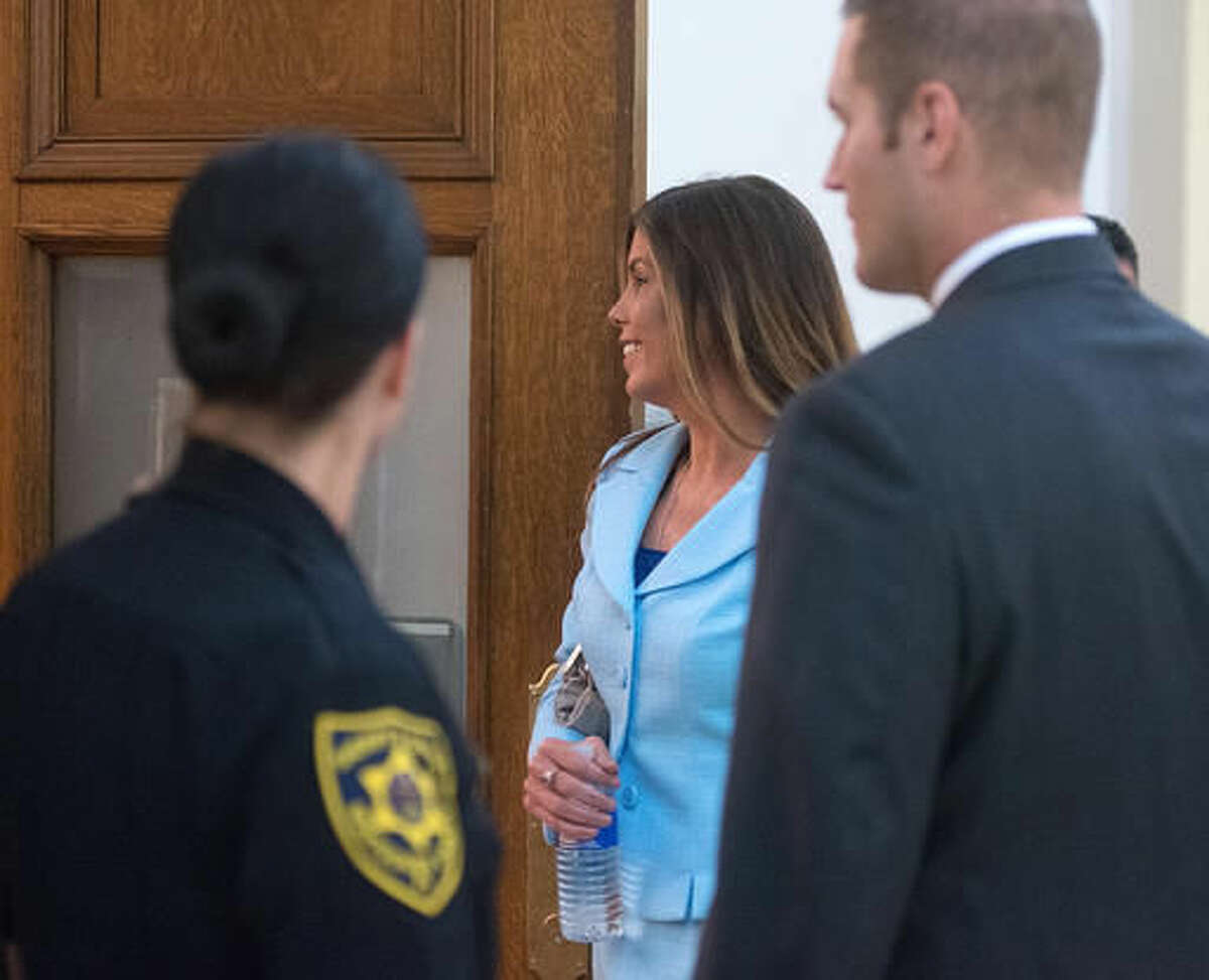 Pennsylvania Attorney General Kathleen Kane, center, walks into the courtroom on the opening day of her trial at the Montgomery County Courthouse Monday, Aug. 8, 2016 in Norristown, Pa. An ethics board accused her of "egregious conduct" amid criminal charges she leaked grand jury material to a newspaper to embarrass enemies and then lied about it under oath. (Bill Fraser/Bucks County Courier Times via AP)