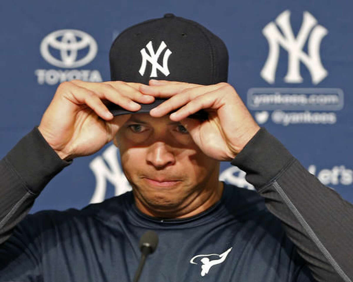 New York Yankees designated hitter Alex Rodriguez struggles putting on his cap before announcing that Friday, Aug. 12, 2016, will be his last game as a player during a press conference at Yankee Stadium in New York, Sunday, Aug. 7, 2016. Rodriguez will continue on in a role as a special advisor to the team and an instructor through Dec. 31, 2017. (AP Photo/Kathy Willens)