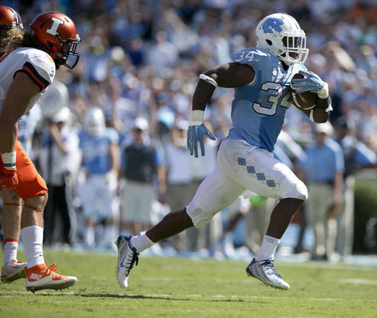 FILE - In this Sept. 19, 2015, file photo, North Carolina tailback Elijah Hood (34) races to the end zone for a 28-yard touchdown during an NCAA football game against Illinois, in Chapel Hill, N.C. Hood ran for 17 touchdowns last year for the Coastal Division champion Tar Heels. (Robert Willett/The News & Observer via AP, File)