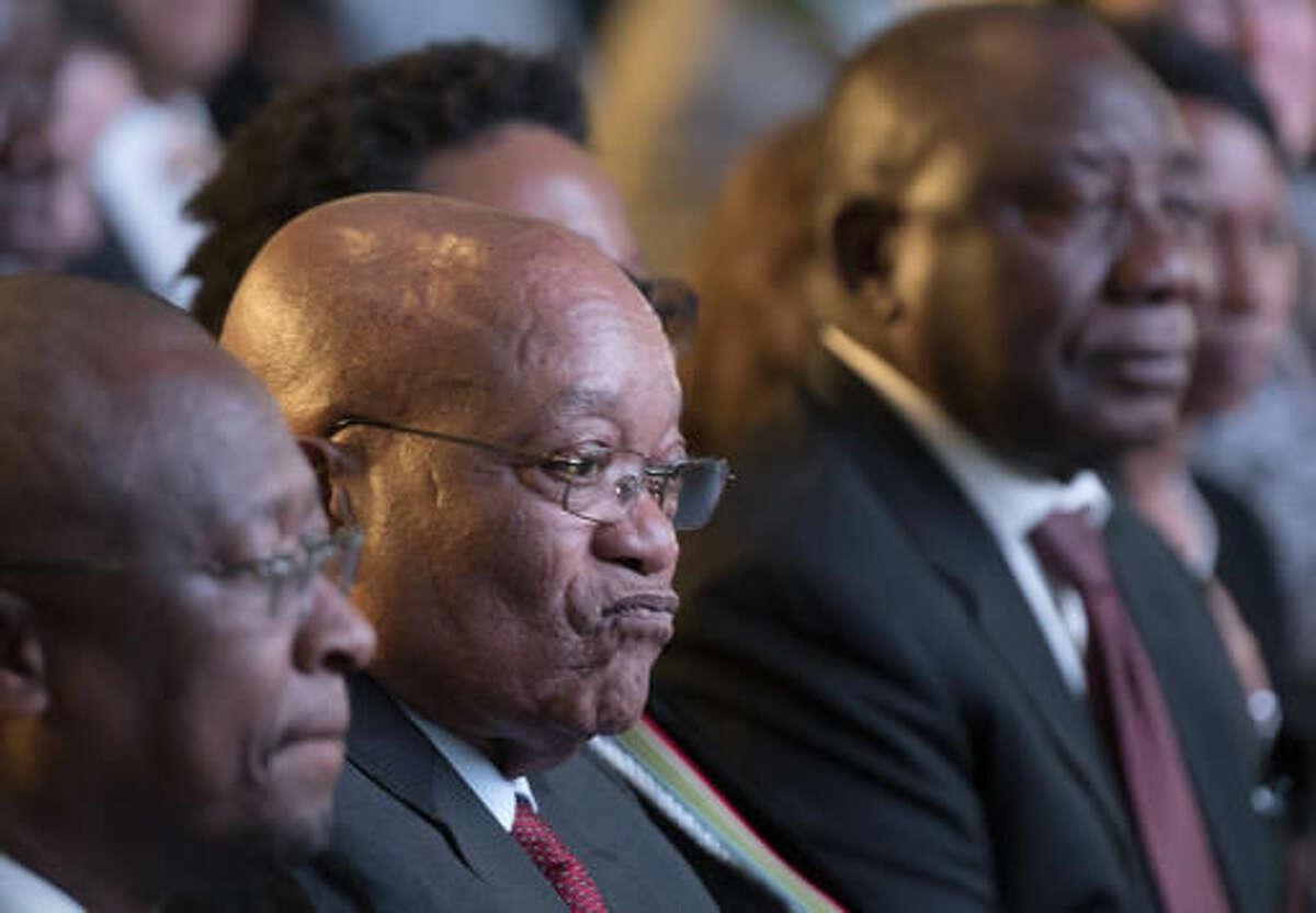 President Jacob Zuma, center, and deputy president Cyril Ramaphosa, right, attend the declaration announcement of the municipal elections in Pretoria, South Africa, Saturday, Aug. 6, 2016. This is the worst-ever election showing for South Africa's ruling party, The African National Congress (ANC), after corruption scandals and a stagnant economy that has frustrated the urban middle class. (AP Photo/Herman Verwey)