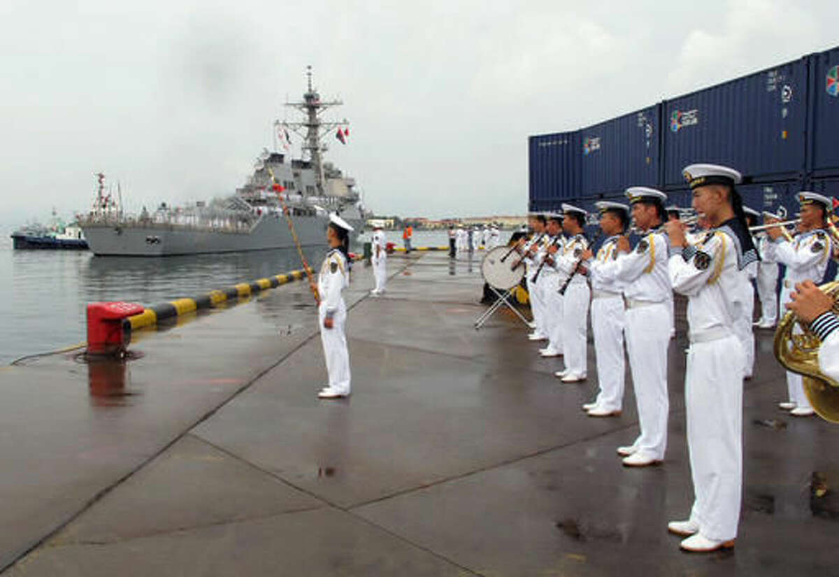 FILE - In this Monday, Aug. 8, 2016, file photo, a Chinese military band plays as the guided missile destroyer USS Benfold arrives in port in Qingdao in eastern China's Shandong Province. The visit of the U.S. Navy's USS Benfold to the northern Chinese port of Qingdao this week is the latest development in a long-term effort to build trust between the countries' militaries amid tensions and a rivalry for dominance in Asia. (AP Photo/Borg Wong, File)