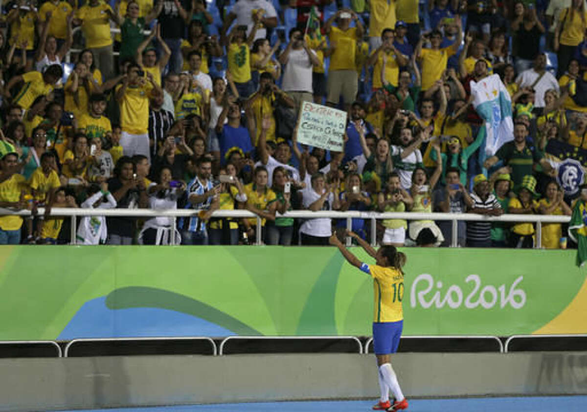 Brazil's Marta celebrates her team's victory with the crowd after a group E match of the women's Olympic football tournament between Sweden and Brazil at the Rio Olympic Stadium in Rio De Janeiro, Brazil, Saturday, Aug. 6, 2016. Brazil won the match 5-1. (AP Photo/Leo Correa)