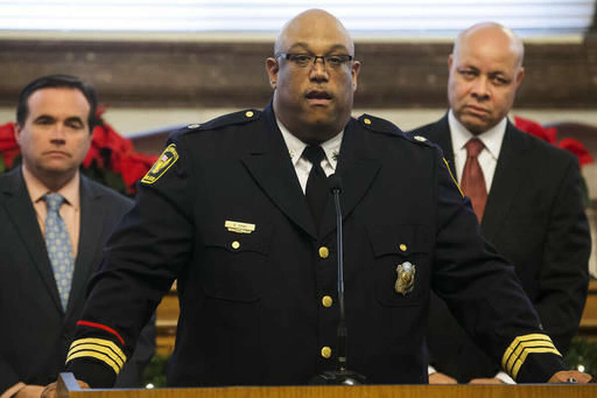 FILE - In this Dec. 10, 2015, file photo, Cincinnati Police Chief Eliot Isaac, center, Cincinnati Mayor John Cranley, left, and Cincinnati City Manager Harry Black, right, discuss Isaac's appointment as the city's permanent police chief during a news conference in Cincinnati. Following the fatal shooting of robbery suspect Jawari Porter on Sunday, Aug. 7, 2016, Cincinnati Police Chief Eliot Isaac says 25-year veteran police Officer Anthony Brucato had no choice but to fire at Porter, and Cincinnati Mayor John Cranley says Porter was trying to kill Brucato, who suffered minor injuries. (AP Photo/John Minchillo, File)