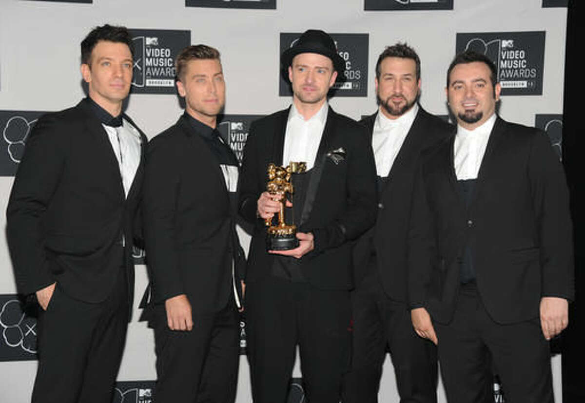 FILE - In this Aug. 25, 2013, file photo, Justin Timberlake, center, winner of the video vanguard award poses backstage with, from left, JC Chasez, Lance Bass, Joey Fatone and Chris Kirkpatrick of NSYNC at the MTV Video Music Awards at the Barclays Center in New York. Timberland and the band's Twitter account posted a picture of the group celebrating Chasez's 40th birthday party on Aug. 9, 2016. (Photo by Evan Agostini/Invision/AP, File)