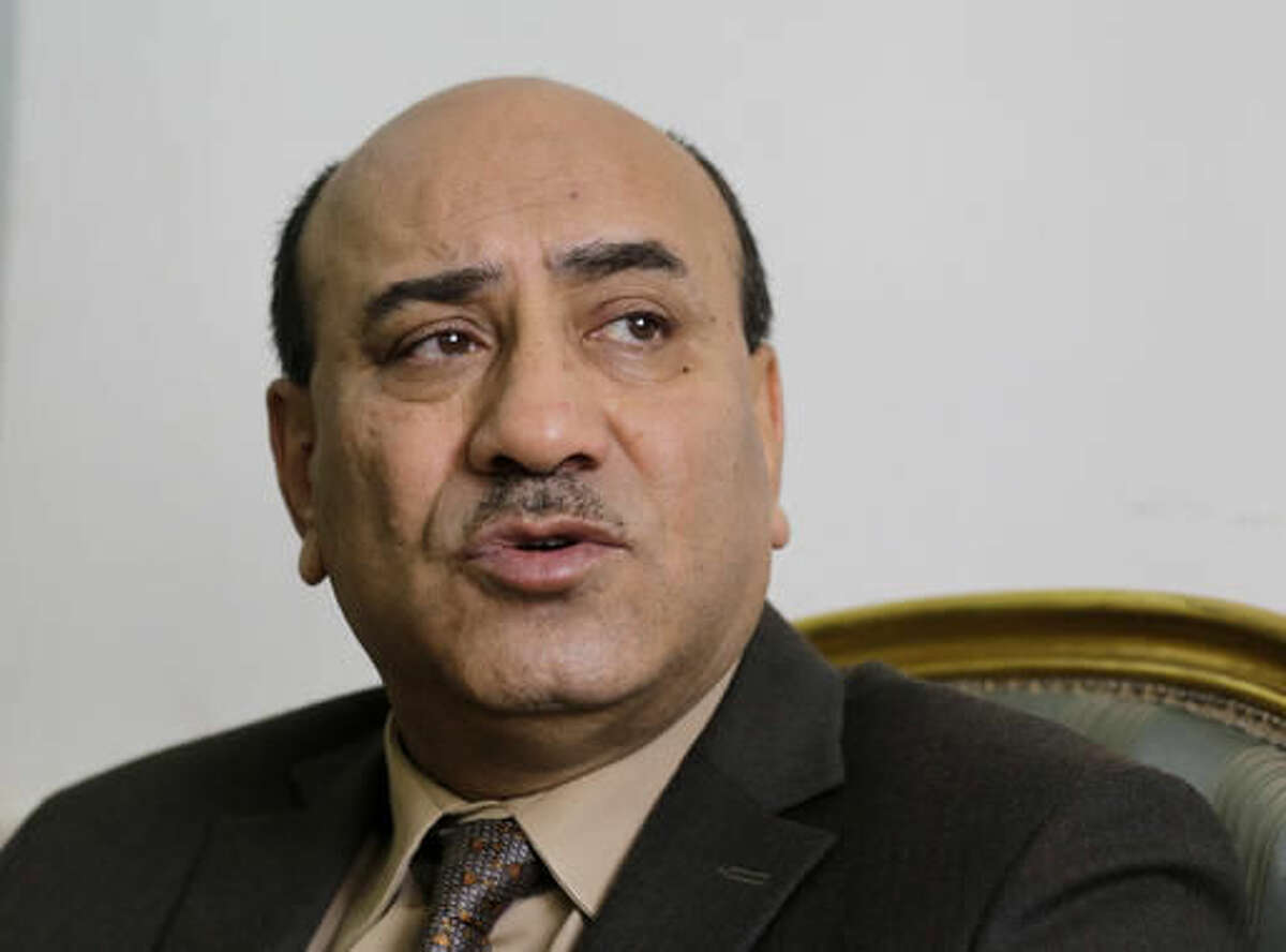 FILE - In this April 16, 2014 file photo, Hesham Genena, then head of Egypt's oversight body, speaks during an interview with the Associated Press at his office in Cairo. Human Rights Watch says the dismissal by Egypt’s president of his country’s top anti-graft official and his conviction of “disseminating false news” violated free speech and set a dangerous precedent. A court convicted Genena in July 2016 over a report he issued claiming that corruption has cost the country 600 billion pounds ($67.6 billion) He escaped going to jail by paying a fine and has appealed the verdict. (AP Photo/Amr Nabil, File)