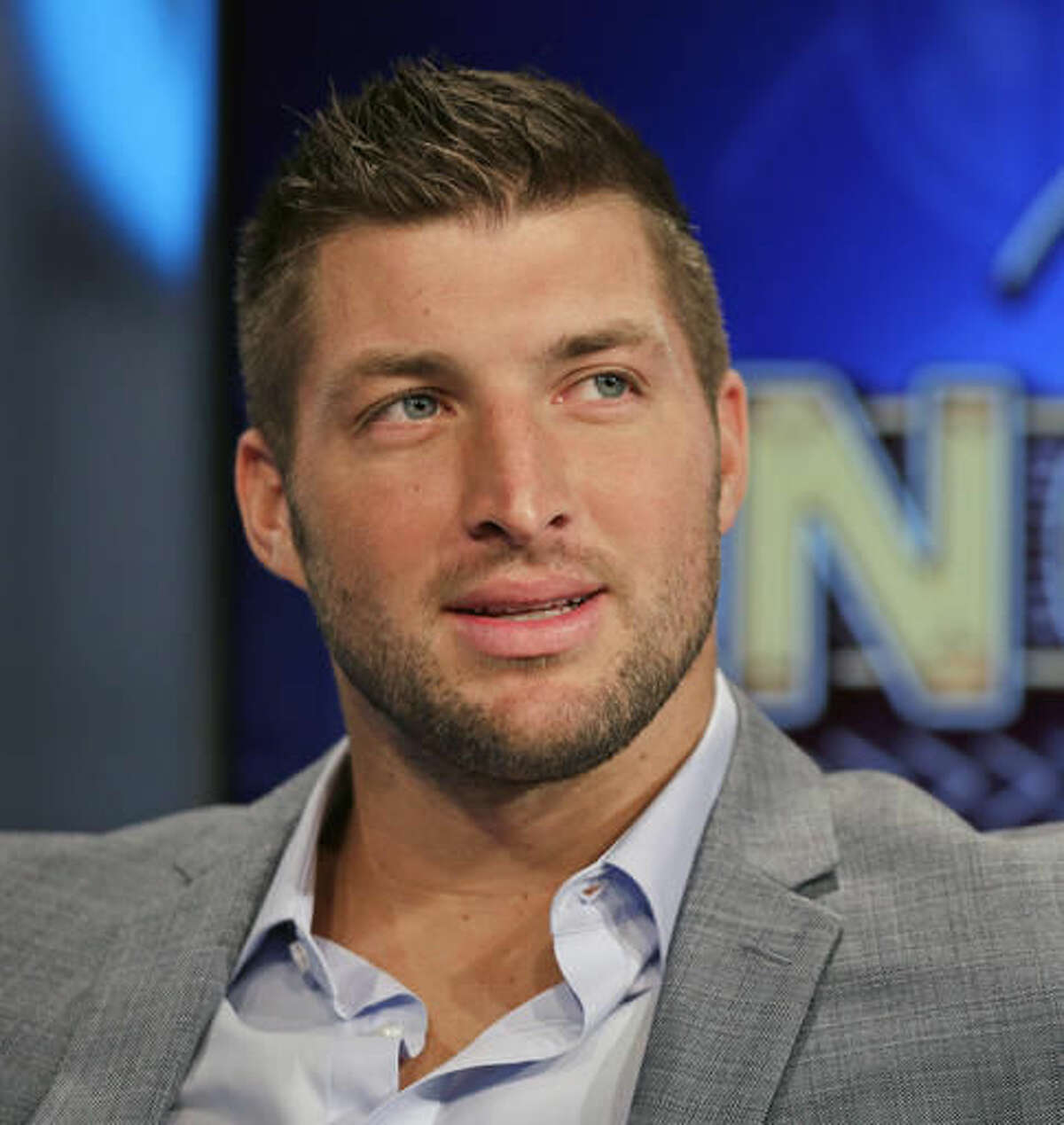 FILE - In this Aug. 6, 2014, file photo, Tim Tebow ponders a question during an interview on the set of ESPN's new SEC Network in Charlotte, N.C. With professional football not working out, Tebow is going to give baseball a try. The 2007 Heisman Trophy winner and former NFL first-round draft pick plans to hold a workout for Major League Baseball teams this month. Tebow last played organized baseball in high school. ESPN first reported the news. (AP Photo/Chuck Burton, File)