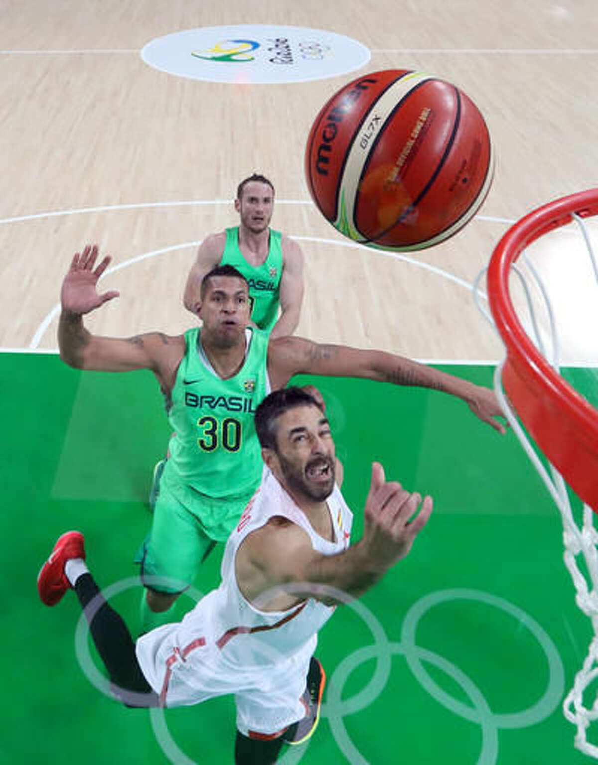 Spain's Ricky Rubio (79) shoots in front of Brazil's Rafael Hettsheimer (30) during a men's basketball game at the 2016 Summer Olympics in Rio de Janeiro, Brazil, Tuesday, Aug. 9, 2016. (Alex Livesey/Pool Photo via AP)