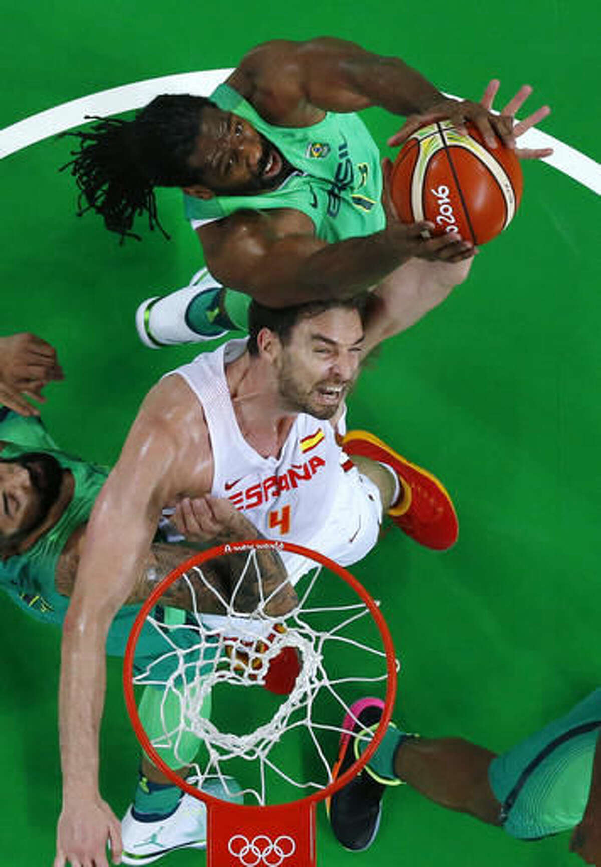 Spain's Pau Gasol (4) fights for a rebound with Brazil's Nene Hilario, top, during a basketball game at the 2016 Summer Olympics in Rio de Janeiro, Brazil, Tuesday, Aug. 9, 2016. (Jim Young/Pool Photo via AP)
