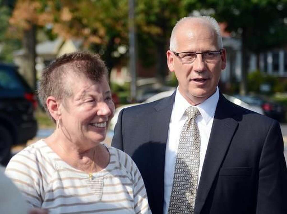 FILE - In this Sept. 3, 2015 file photo, Sharon and Randy Budd talk with friends and relatives outside the Union County Court House in Lewisburg, Pa., after three young men were sentenced to time behind bars for throwing a rock off a highway overpass in central Pennsylvania, causing severe brain trauma to Sharon, an Ohio teacher. Randy Budd, has died at age 55. Harry Campbell, chief investigator for the Stark County Coroner’s office, told The Associated Press on Sunday, Aug. 7, 2016, that Budd died of a self-inflicted gunshot wound and was pronounced dead at his Uniontown, Ohio, home late Saturday. (Amanda August/The Daily Item via AP, File)