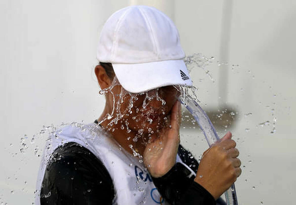 Hungary's Maria Erdi washes her face after competing in the women's Laser Radial sailing race at the 2016 Summer Olympics in Rio de Janeiro, Brazil, Tuesday, Aug. 9, 2016. (AP Photo/David Goldman)