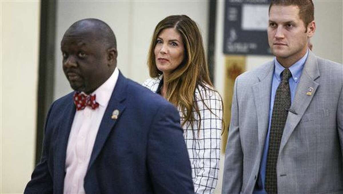 Pennsylvania Attorney General Kathleen Kane, center, walks to the courtroom during a short recess on the second day of her trial at the Montgomery County Courthouse in Norristown, Pa., Tuesday, Aug. 9, 2016. Kane faces perjury and other charges related to the alleged leak of secret grand jury materials. (Dan Gleiter/PennLive.com via AP, Pool)