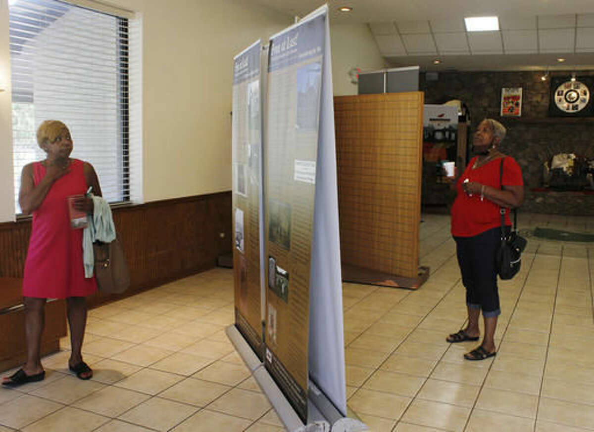 In this Monday, Aug. 1, 2016, photo, Eleanor Simms, left, and Renee Burley-Anderson walk through the "Free at Last!" exhibit at the West Tennessee Delta Heritage Center in Brownsville, Tenn. (Emily Littleton/The Jackson Sun via AP)