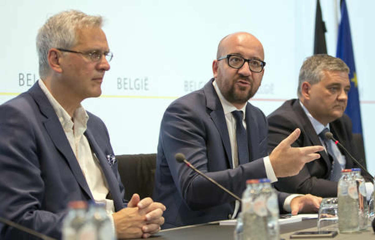 Belgian Prime Minister Charles Michel, center, speaks during a media conference at the prime ministers office in Brussels on Sunday, Aug. 7, 2016. A man attacked two police officers with a machete near the police headquarters in Charleroi, Belgium on Saturday, Aug. 6, 2016 before being apprehended. (AP Photo/Virginia Mayo)