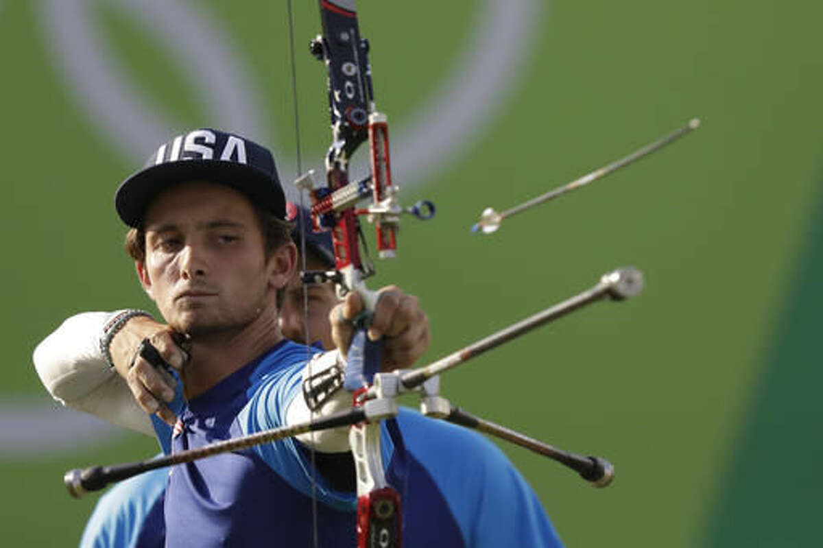 Zach Garrett of the United States releases his arrow during the men's team archery competition at the Sambadrome venue during the 2016 Summer Olympics in Rio de Janeiro, Brazil, Saturday, Aug. 6, 2016.(AP Photo/Natacha Pisarenko)