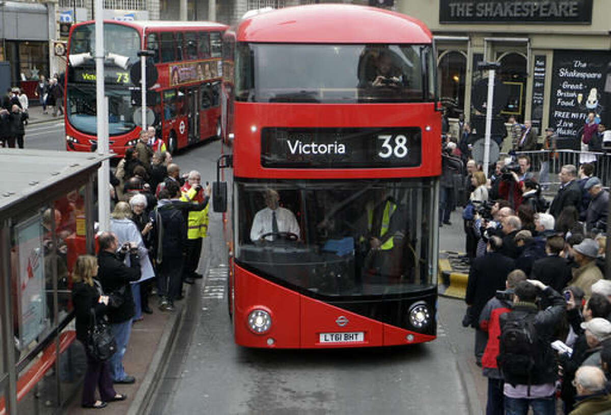 FILE - In this Monday, Feb. 27, 2012 file photo, a new Routemaster double decker bus arrives at Victoria bus station in London. Londoners will soon be able to get air quality reports when they check whether their bus is about to arrive. Mayor Sadiq Khan has ordered that 2,500 bus stop information signs display air quality alerts on high pollution days. The initiative, which begins Aug. 15, 2016 is part of Khan's crusade to clean up the air in the British capital. (AP Photo/Sang Tan, file)