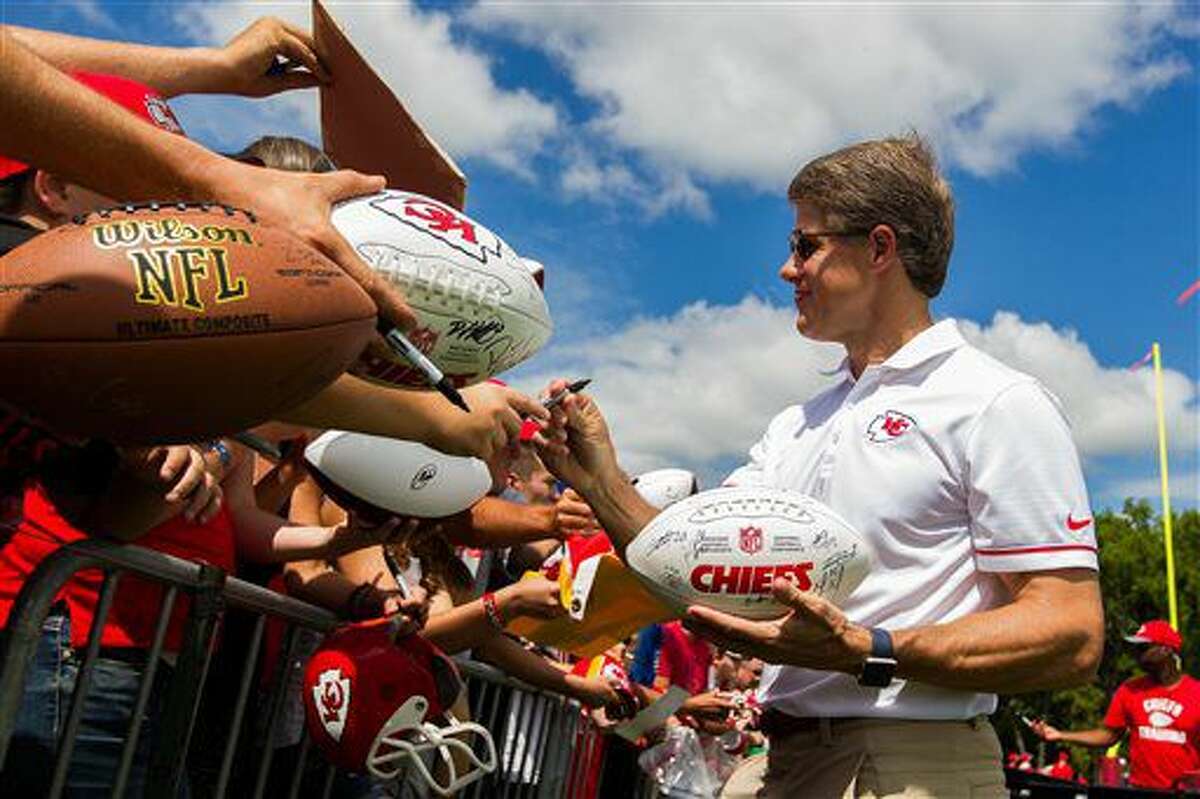 Kansas City Chiefs chairman and CEO Clark Hunt signs fans various items during an autograph session during NFL football training camp Saturday, Aug. 6, 2016, in St. Joseph, Mo. (Dougal Brownlie/The St. Joseph News-Press via AP)