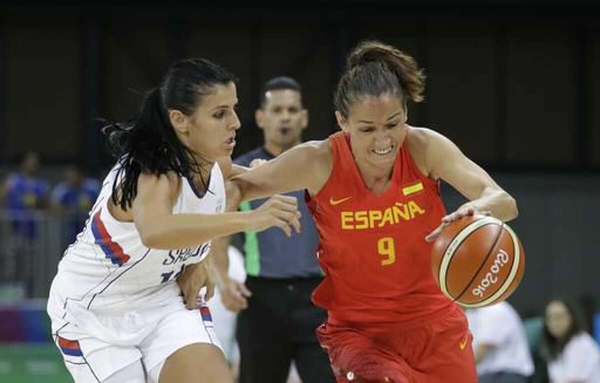 Spain guard Laia Palau drives on Serbia guard Ana Dabovic during the first half of a women's basketball game at the Youth Center at the 2016 Summer Olympics in Rio de Janeiro, Brazil, Sunday, Aug. 7, 2016. (AP Photo/Carlos Osorio)