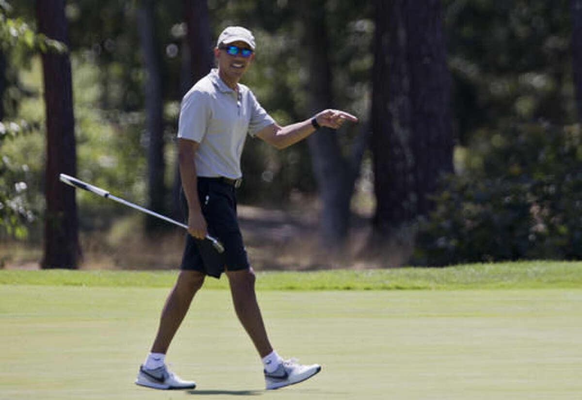 President Barack Obama reacts after putting on the first green as he plays golf at Farm Neck Golf Course in Oak Bluffs, Mass., on Martha's Vineyard, Sunday, Aug. 7, 2016. The president and his family are vacationing on the Massachusetts island of Martha's Vineyard. (AP Photo/Manuel Balce Ceneta)