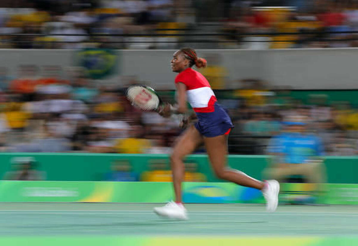 In this picture shot with a slow shutter speed Venus Williams of the United States runs to the net during the match against Belgium's Kirsten Flipkens in the women's tennis competition at the 2016 Summer Olympics in Rio de Janeiro, Brazil, Saturday, Aug. 6, 2016. (AP Photo/Vadim Ghirda)