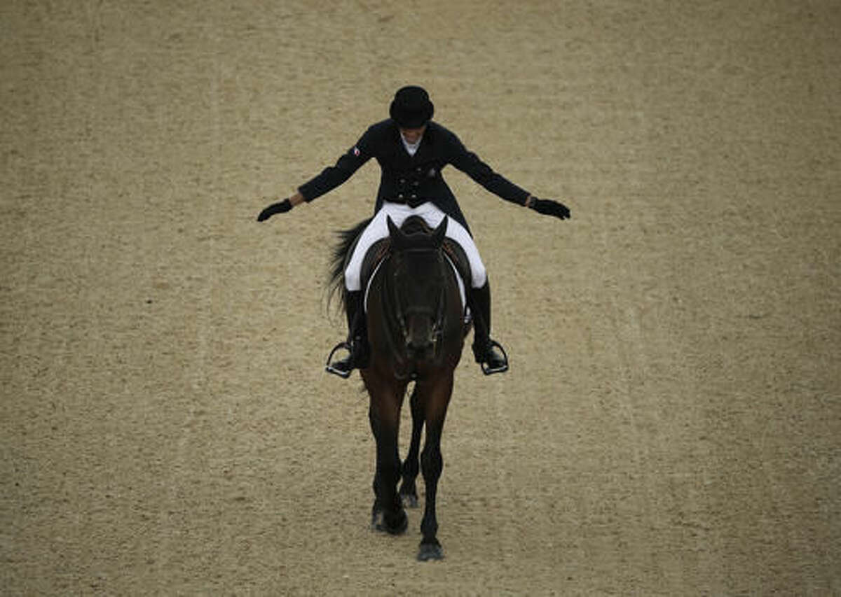 Mathieu Lemoine, of France, celebrates on Bart L after riding in the equestrian eventing dressage competition at the 2016 Summer Olympics in Rio de Janeiro, Brazil, Sunday, Aug. 7, 2016. (AP Photo/John Locher)a