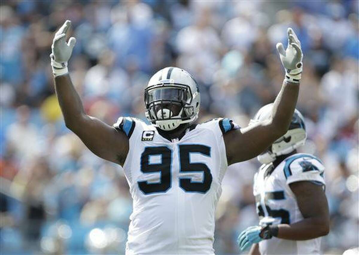 FILE - In this Sept. 20, 2015, file photo, Carolina Panthers' Charles Johnson (95) fires up the crowd during the second half of an NFL football game against the Houston Texans in Charlotte, N.C. Johnson, who has spent all nine seasons with the team, agreed to take an $8 million pay cut this offseason to return this season. (AP Photo/Bob Leverone, File)