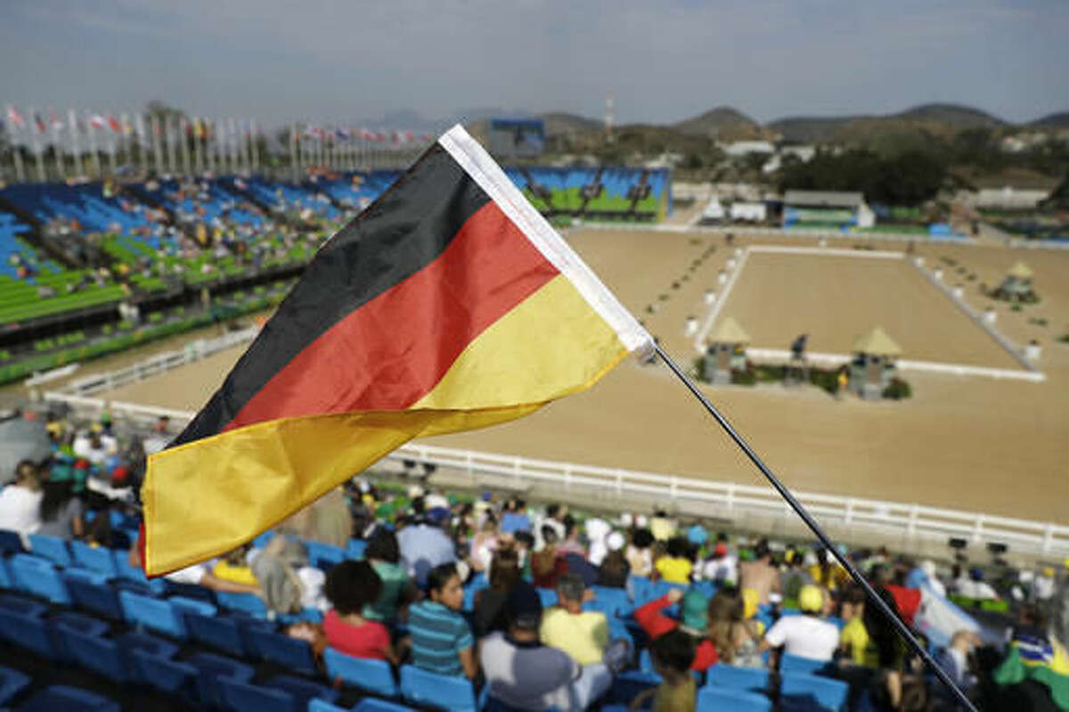 A German fan waves a flag during the equestrian eventing dressage competition at the 2016 Summer Olympics in Rio de Janeiro, Brazil, Saturday, Aug. 6, 2016. (AP Photo/John Locher)